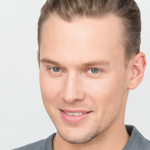 Joyful white young-adult male with short  brown hair and brown eyes