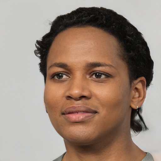 Joyful black young-adult female with short  black hair and brown eyes