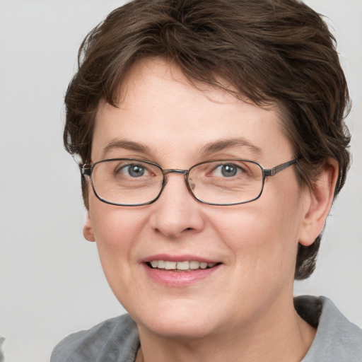 Joyful white adult female with short  brown hair and grey eyes