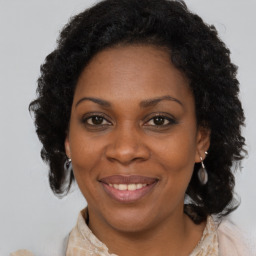 Joyful black adult female with medium  brown hair and brown eyes