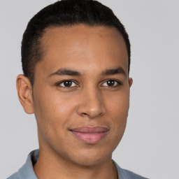 Joyful latino young-adult male with short  brown hair and brown eyes