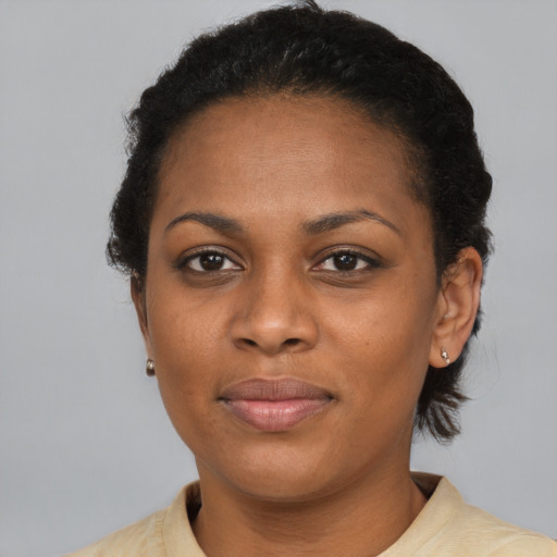 Joyful black adult female with short  black hair and brown eyes