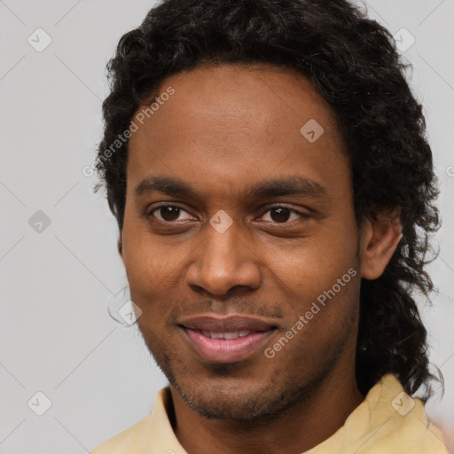 Joyful black young-adult male with short  brown hair and brown eyes