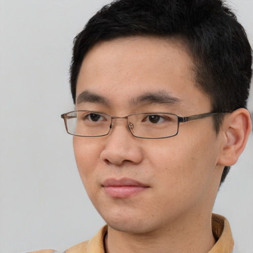 Joyful asian young-adult male with short  brown hair and brown eyes