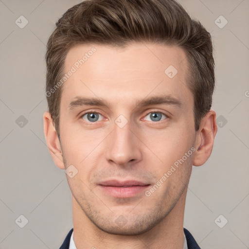 Joyful white young-adult male with short  brown hair and grey eyes