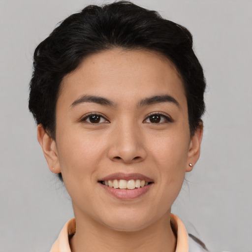 Joyful asian young-adult female with short  brown hair and brown eyes