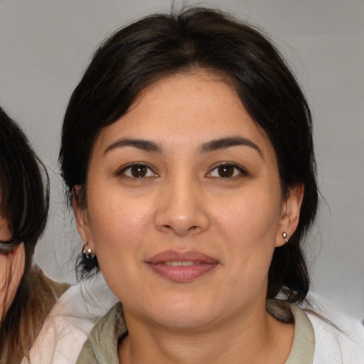 Joyful white young-adult female with medium  brown hair and brown eyes