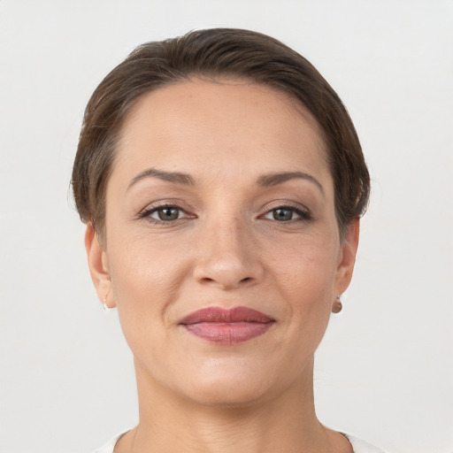 Joyful white adult female with short  brown hair and brown eyes