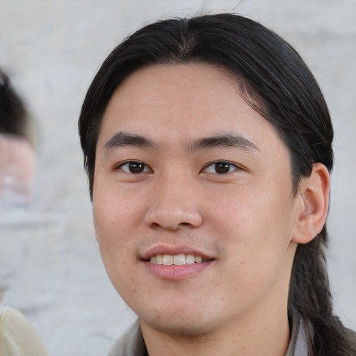 Joyful white young-adult male with medium  black hair and brown eyes