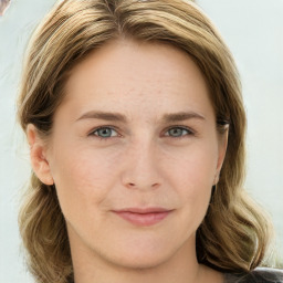 Joyful white young-adult female with long  brown hair and green eyes