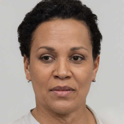 Joyful black adult female with short  black hair and brown eyes