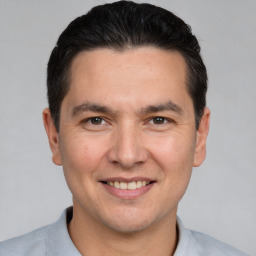 Joyful white adult male with short  brown hair and brown eyes