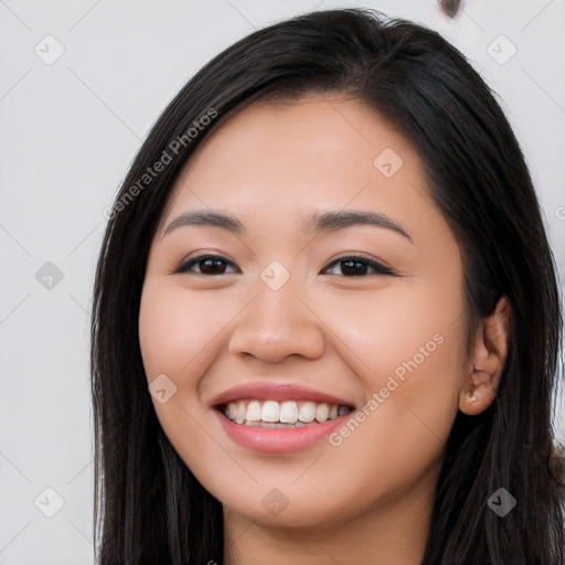 Joyful latino young-adult female with long  black hair and brown eyes