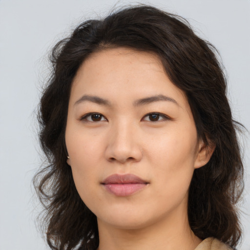 Joyful asian young-adult female with long  brown hair and brown eyes