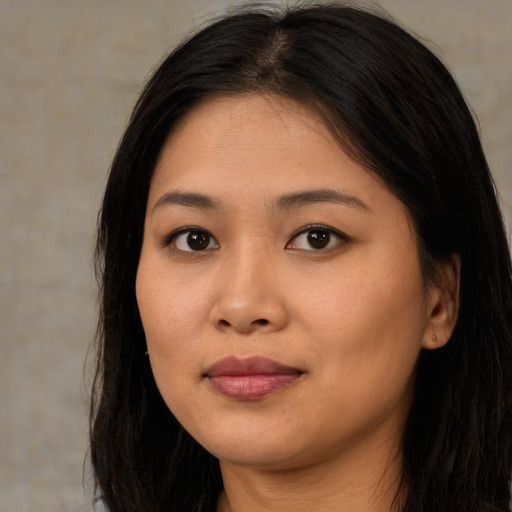 Joyful asian young-adult female with long  brown hair and brown eyes