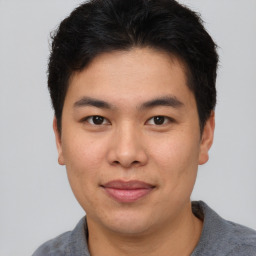 Joyful asian young-adult male with short  brown hair and brown eyes