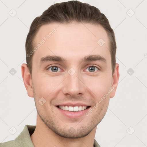 Joyful white young-adult male with short  brown hair and grey eyes