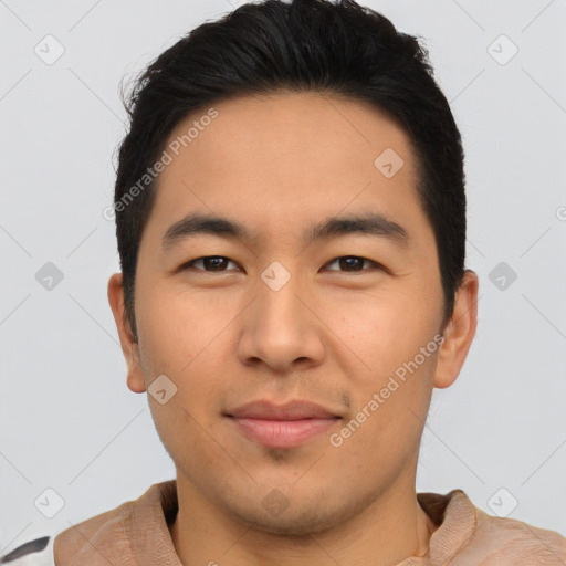 Joyful asian young-adult male with short  brown hair and brown eyes