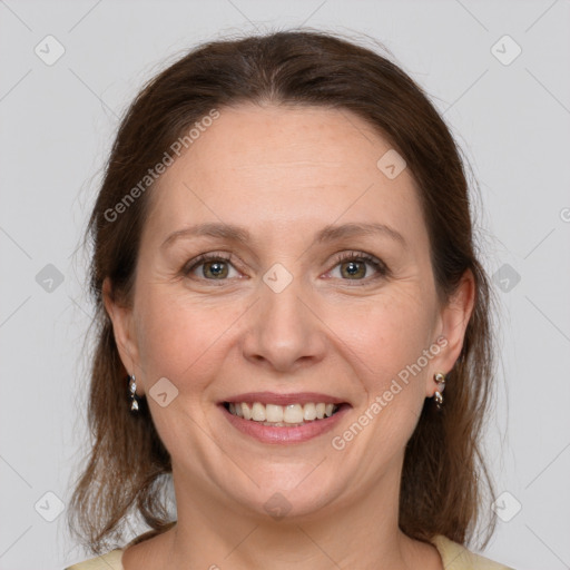 Joyful white adult female with medium  brown hair and grey eyes