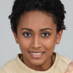 Joyful black young-adult female with short  brown hair and brown eyes