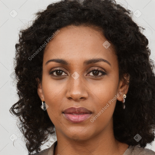 Joyful black young-adult female with long  brown hair and brown eyes