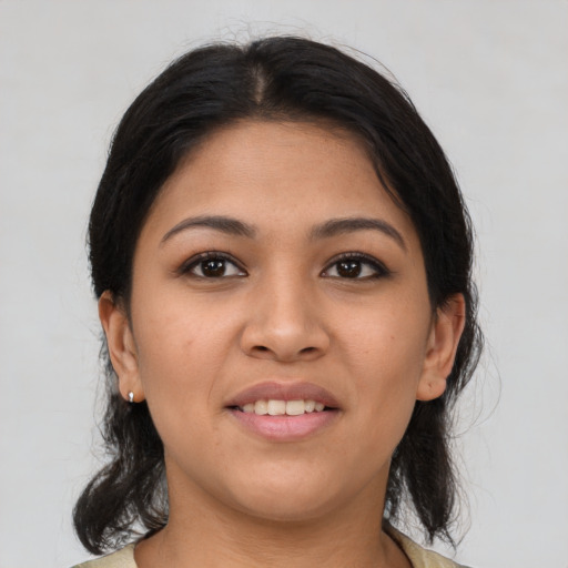 Joyful latino young-adult female with medium  brown hair and brown eyes
