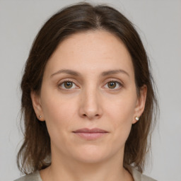 Joyful white young-adult female with medium  brown hair and green eyes