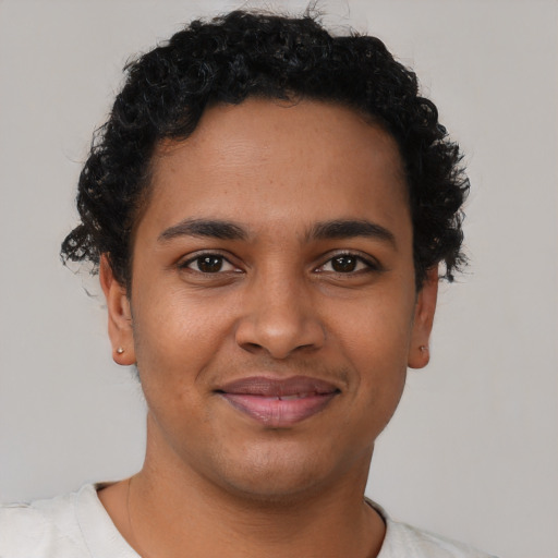 Joyful latino young-adult male with short  brown hair and brown eyes