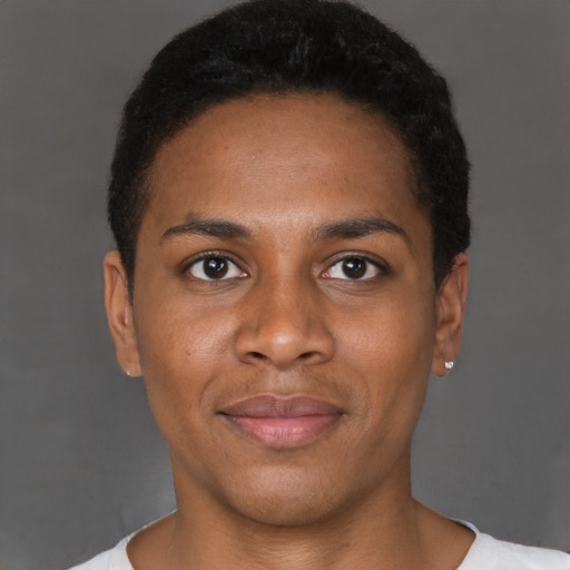 Joyful black young-adult male with short  brown hair and brown eyes