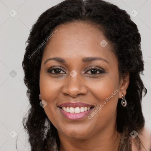 Joyful black young-adult female with long  brown hair and brown eyes