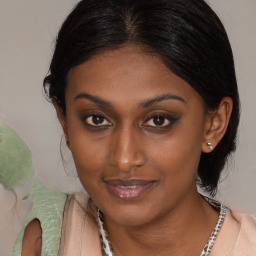 Joyful black young-adult female with medium  brown hair and brown eyes