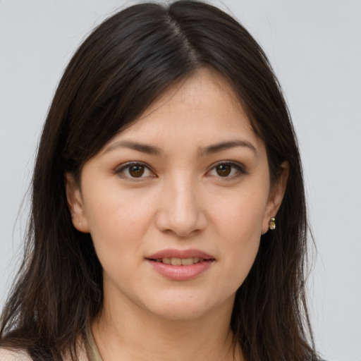 Joyful white young-adult female with long  brown hair and brown eyes