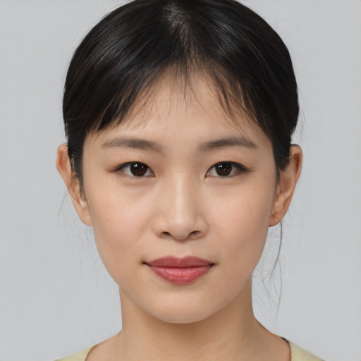 Joyful asian young-adult female with medium  brown hair and brown eyes