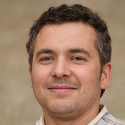 Joyful white adult male with short  brown hair and brown eyes