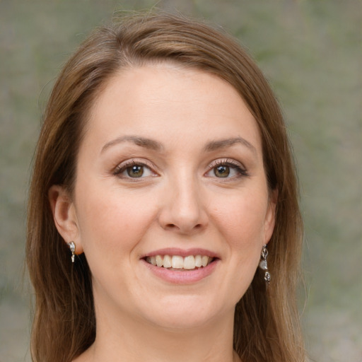 Joyful white young-adult female with medium  brown hair and green eyes