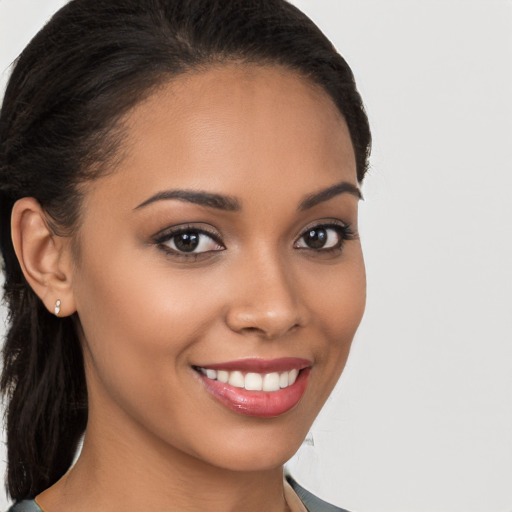 Joyful latino young-adult female with long  brown hair and brown eyes