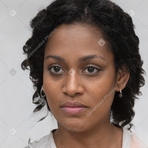 Joyful black young-adult female with medium  brown hair and brown eyes