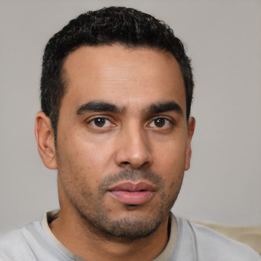 Neutral latino young-adult male with short  black hair and brown eyes