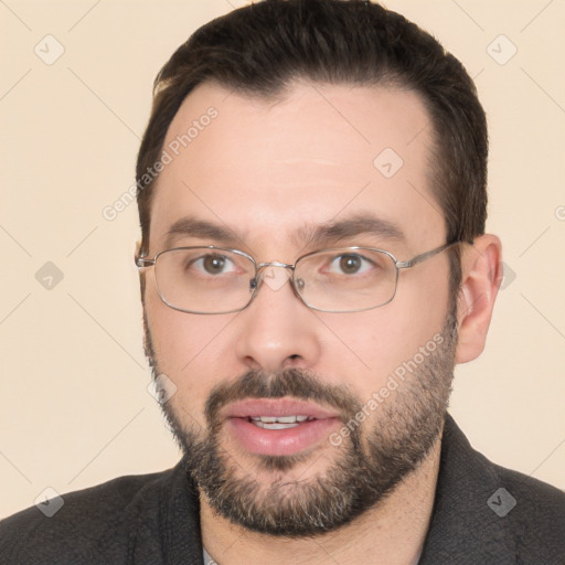 Joyful white young-adult male with short  black hair and brown eyes