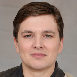 Joyful white adult male with short  brown hair and grey eyes