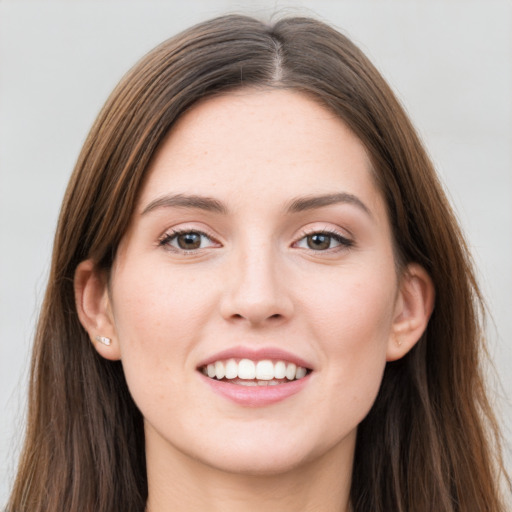 Joyful white young-adult female with long  brown hair and grey eyes