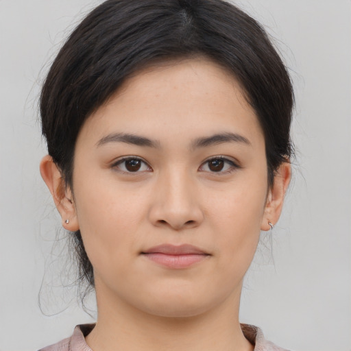 Joyful asian young-adult female with medium  brown hair and brown eyes