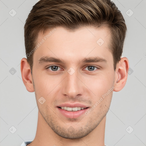 Joyful white young-adult male with short  brown hair and grey eyes