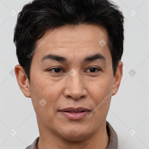 Joyful latino adult male with short  brown hair and brown eyes