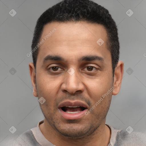 Joyful white adult male with short  black hair and brown eyes