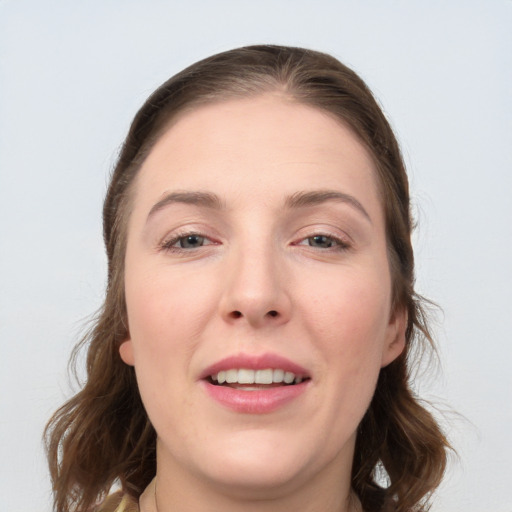 Joyful white young-adult female with medium  brown hair and grey eyes