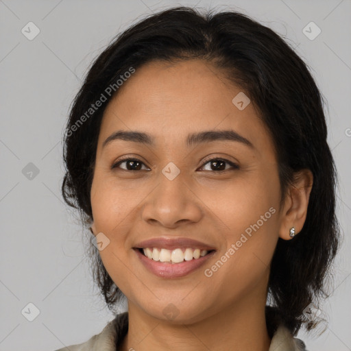 Joyful latino young-adult female with long  brown hair and brown eyes