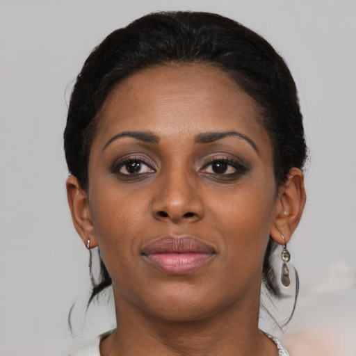 Joyful black young-adult female with medium  black hair and brown eyes