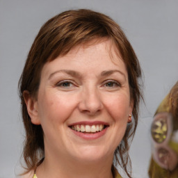 Joyful white adult female with medium  brown hair and brown eyes