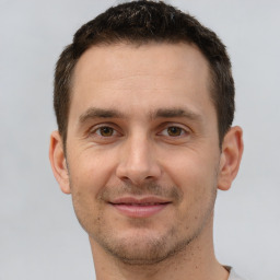 Joyful white young-adult male with short  brown hair and brown eyes